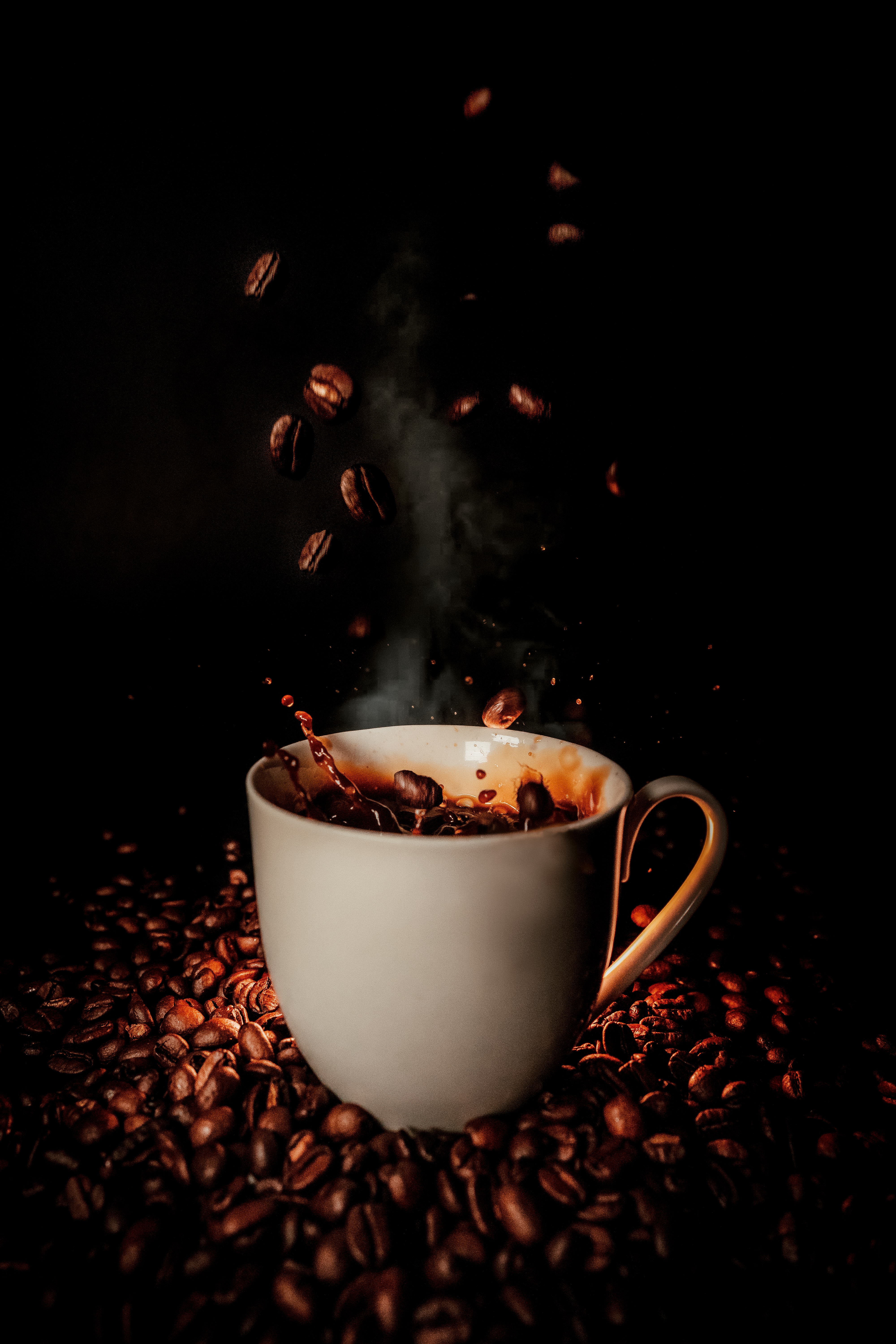 Coffee beans falling into cup
